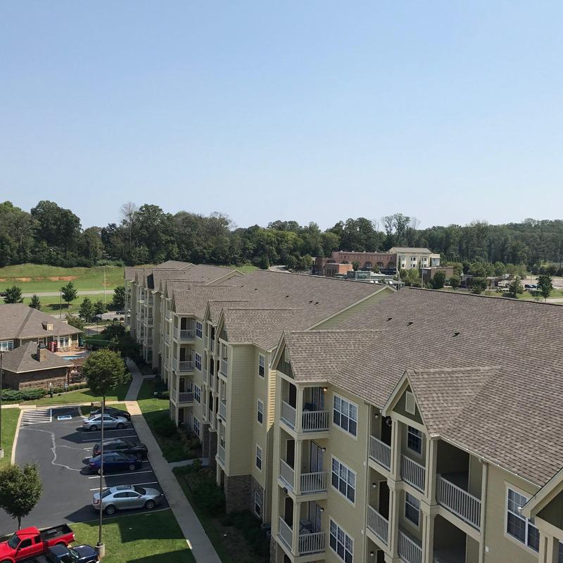 Apartment complex asphalt shingle roof with hail damage