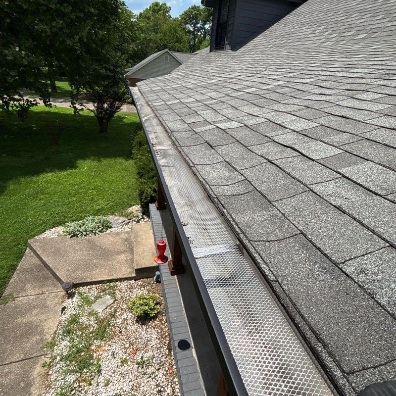 Architectural shingle roof with gutter guard installation