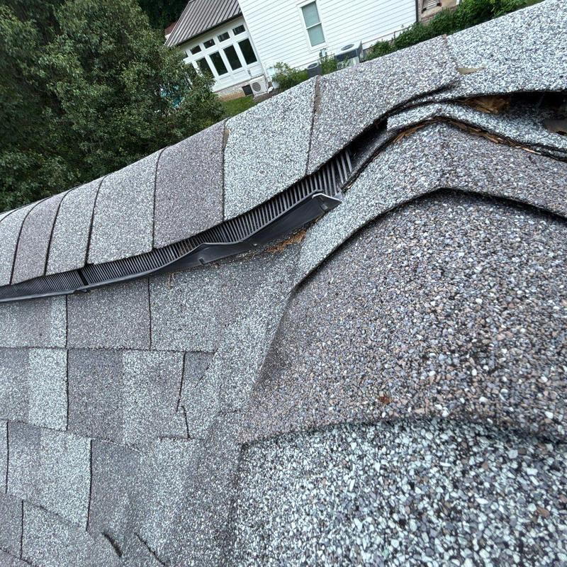 Architectural roof shingles showing hail damage and wear