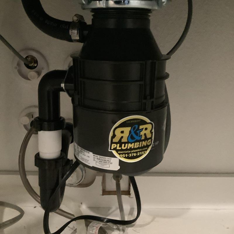 Garbage disposal with rebuilt tubular drain pipe
