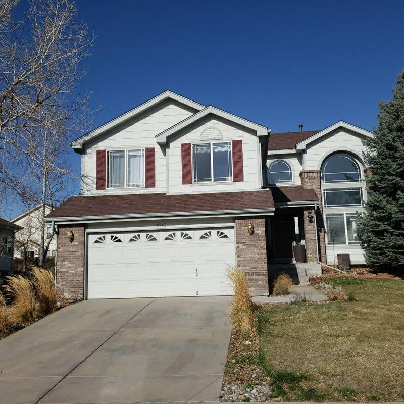 Asphalt shingle roof with hail damage on suburban home
