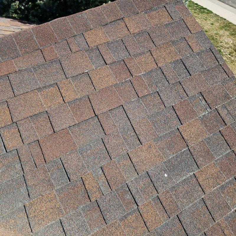 Asphalt shingle roof with hail damage inspection