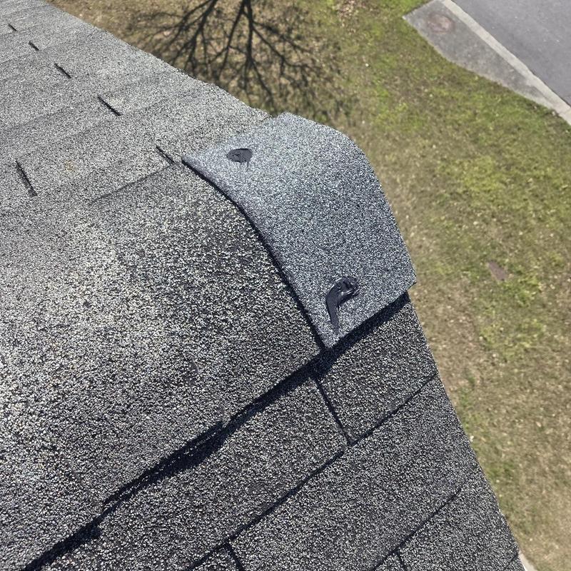 Roof shingles with replaced pipe boot and sealant