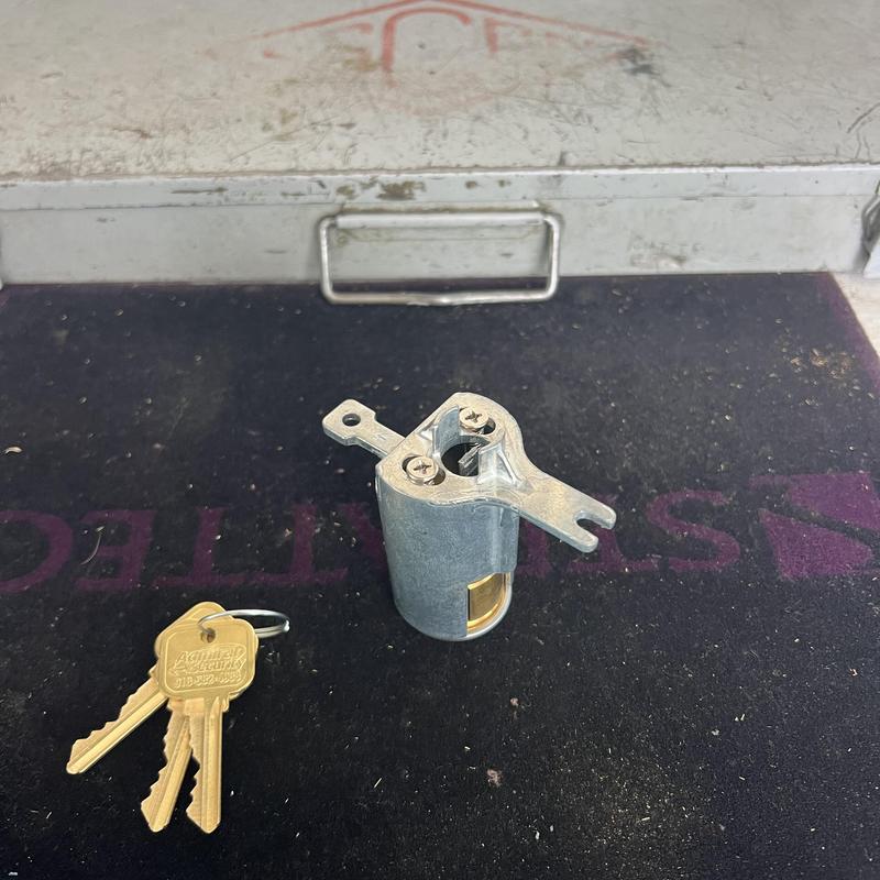 Lock cylinder with new keys on workbench