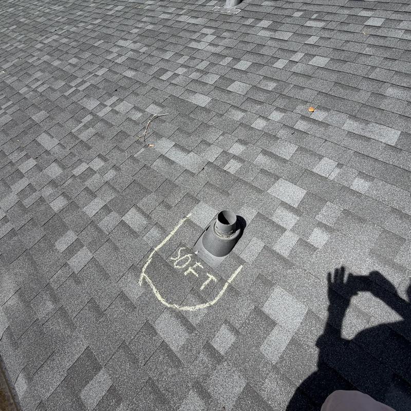 Pipe boot on asphalt shingle roof marked for repair
