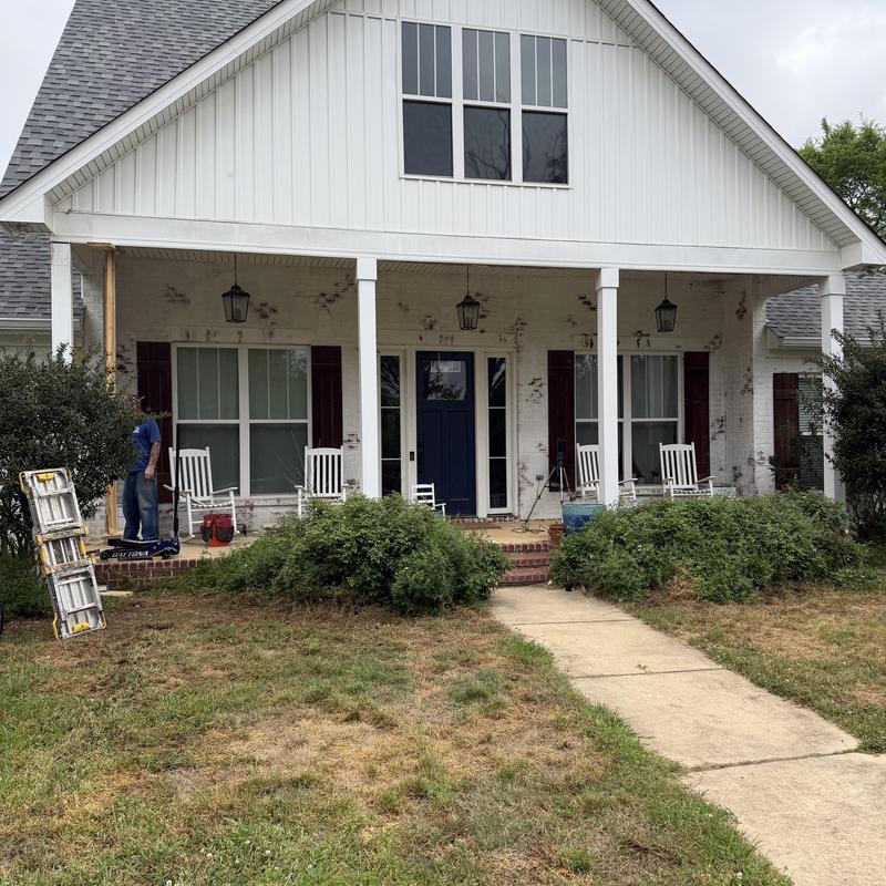 Front porch columns repair with ladders and tools