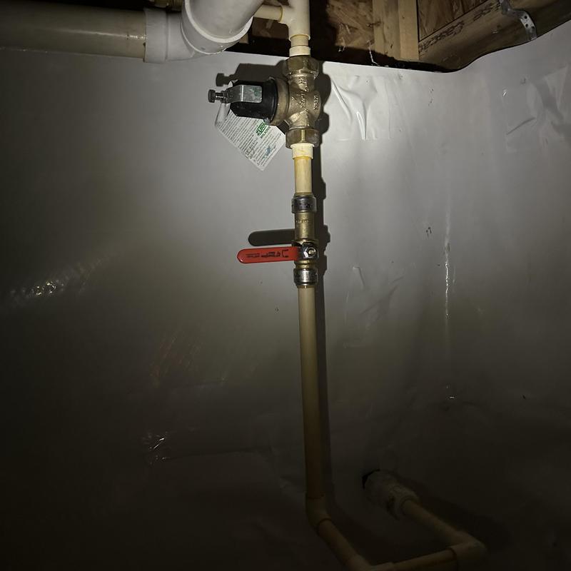 Pressure regulator and valve on residential plumbing pipe