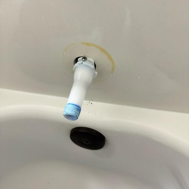 Tub spout base with plumber's tape in bathtub wall