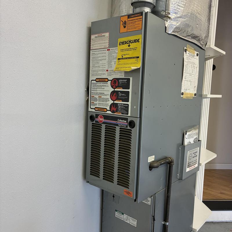 Gas furnace with safety labels and vent pipe Gas furnace with safety labels and vent pipe
