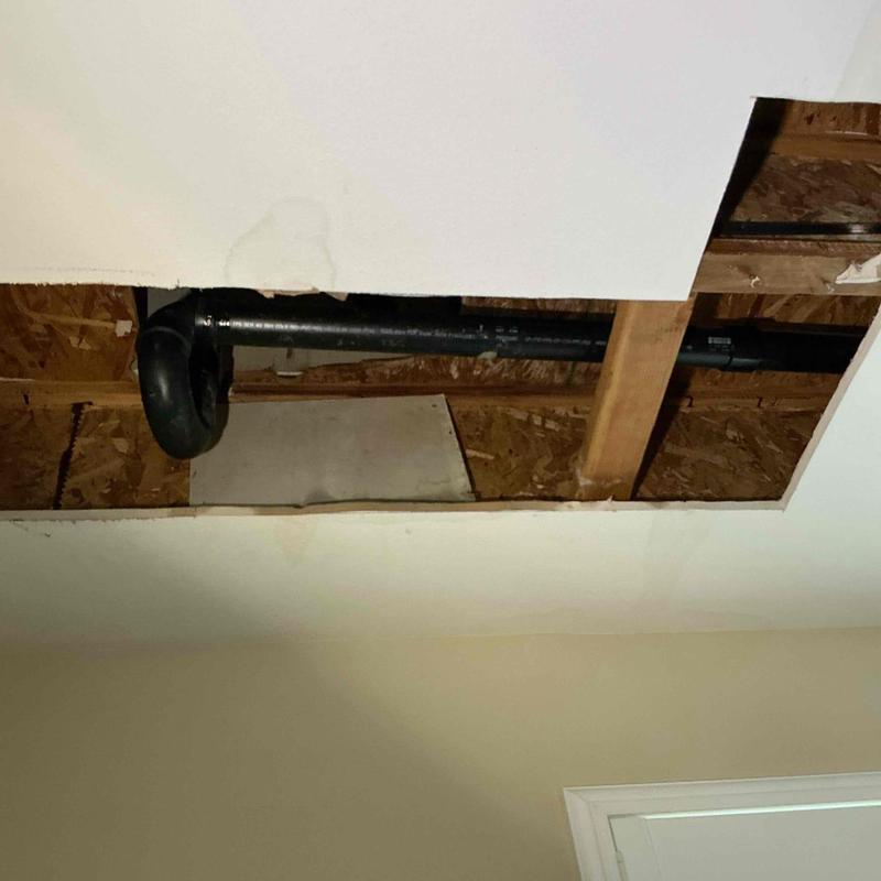 Bathroom drain pipe with ceiling access opened