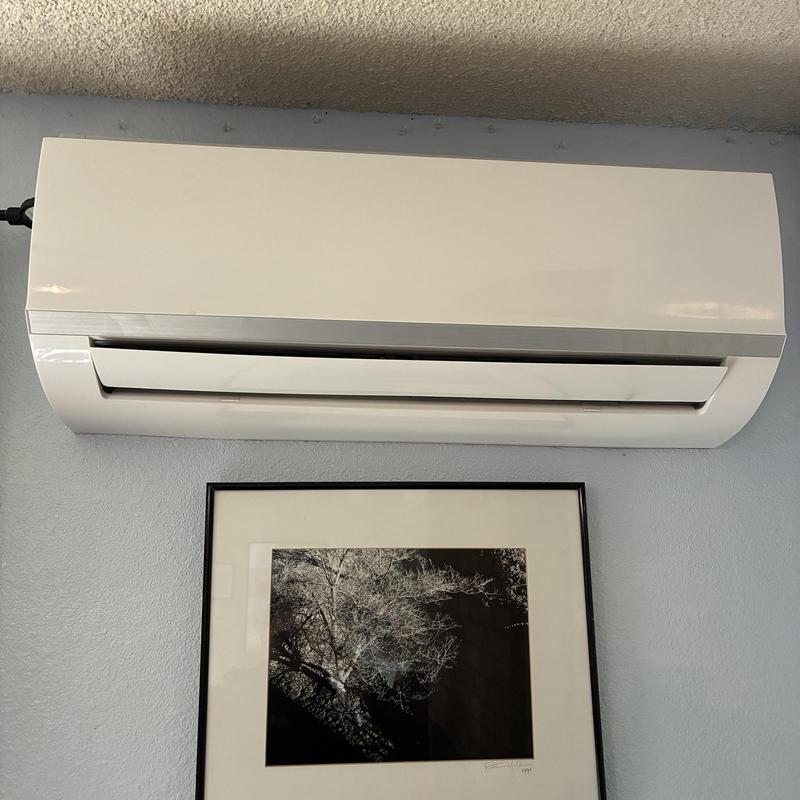 Mini split indoor wall unit on blue wall Mini split indoor wall unit on blue wall