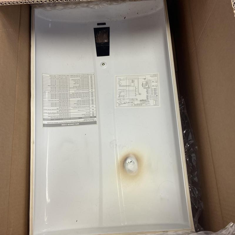 Heat exchanger panel with burn mark in cardboard box