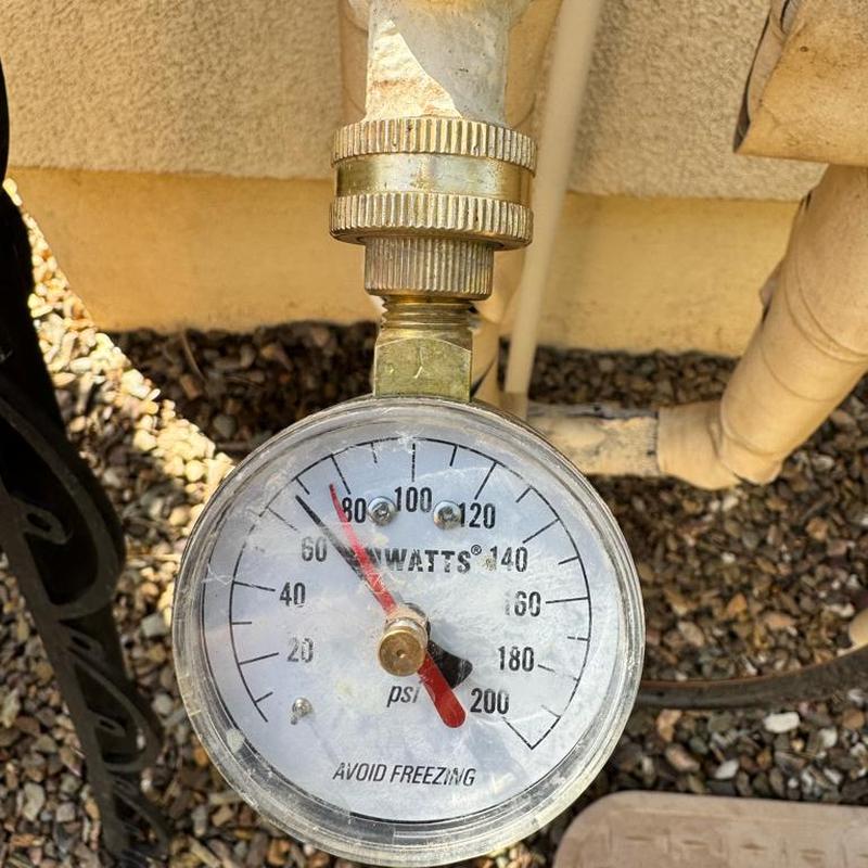 Pressure gauge on irrigation pipe set to 68 psi