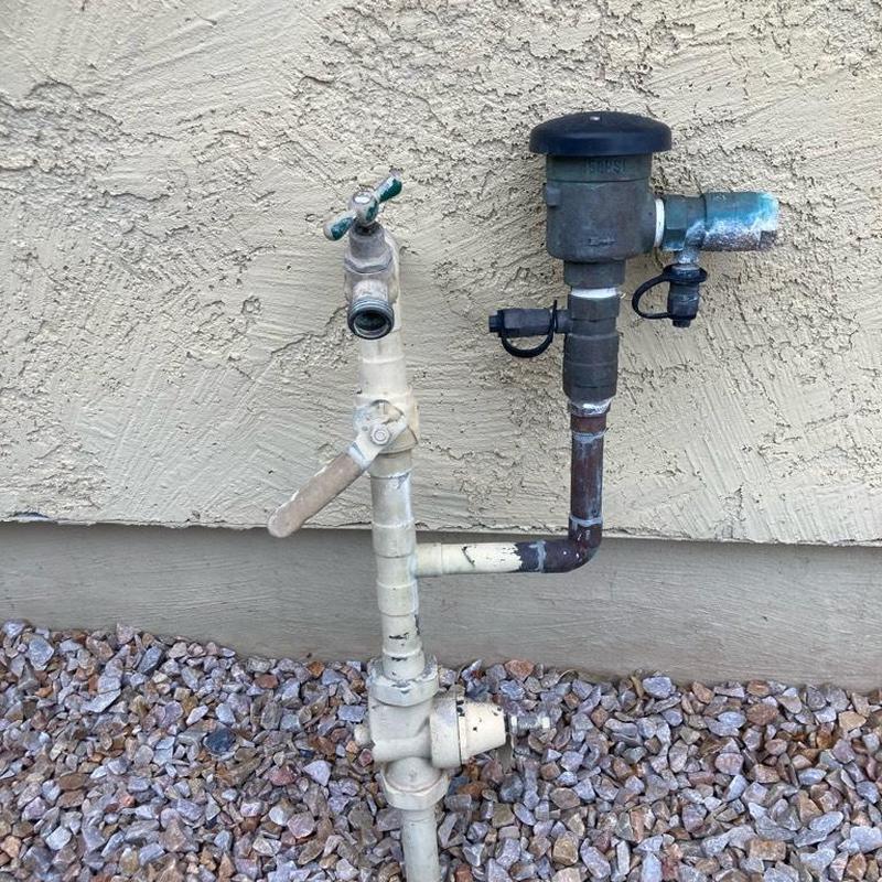 Pressure vacuum breaker and main riser piping near wall