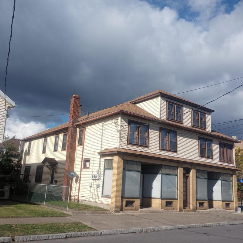 Asphalt shingle roof and chimney on two-story house
