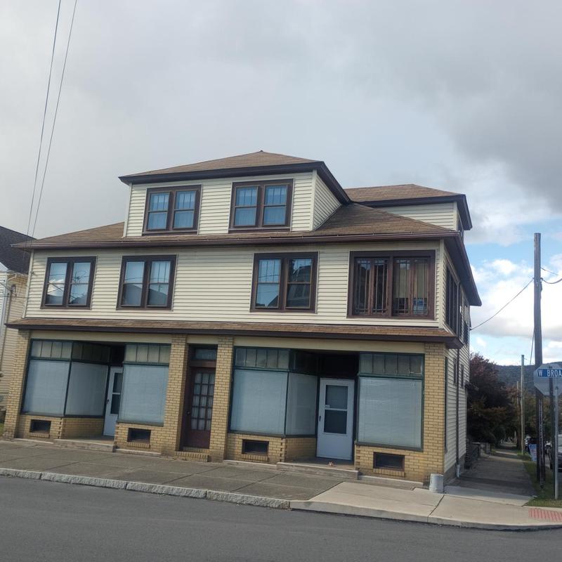 Asphalt shingle roof and siding inspection on multi-story building