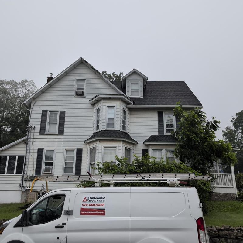 Asphalt shingle roof inspection with roofing van