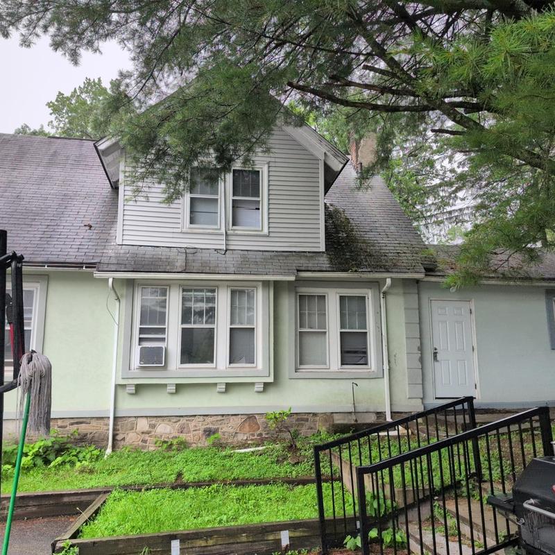 Residential roof shingles inspection on house exterior