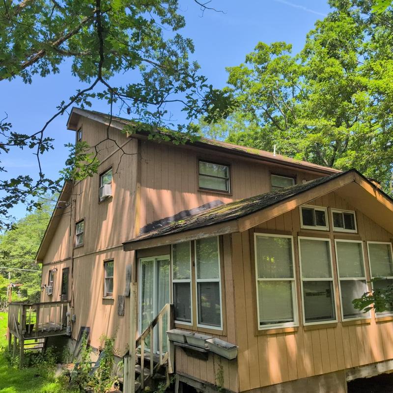 Asphalt shingle roof with moss and debris buildup