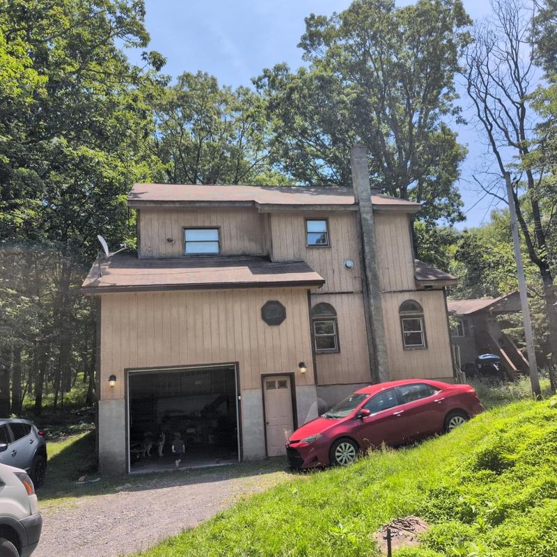 Asphalt shingle roof with garage and red car