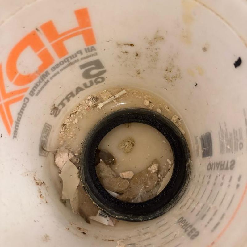 Toilet tank gasket in dirty service bucket Toilet tank gasket in dirty service bucket