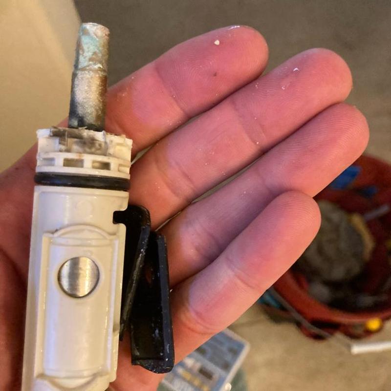 Shower cartridge with mineral buildup in hand