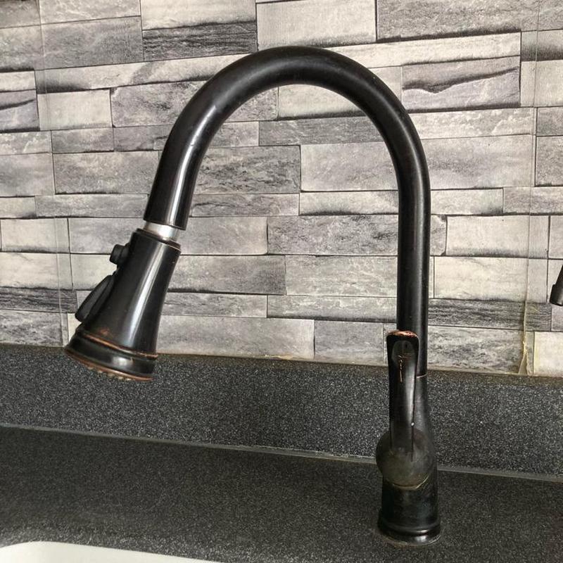 Kitchen faucet with pull-down sprayer on countertop