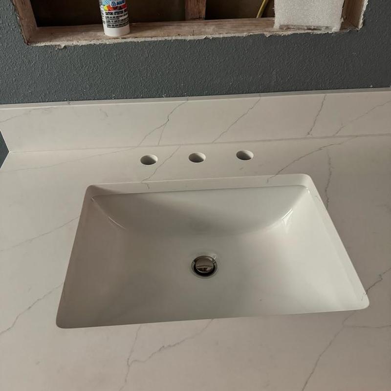 Bathroom sink with holes for widespread faucet installation