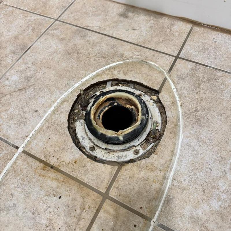 Toilet flange and wax ring on tiled floor