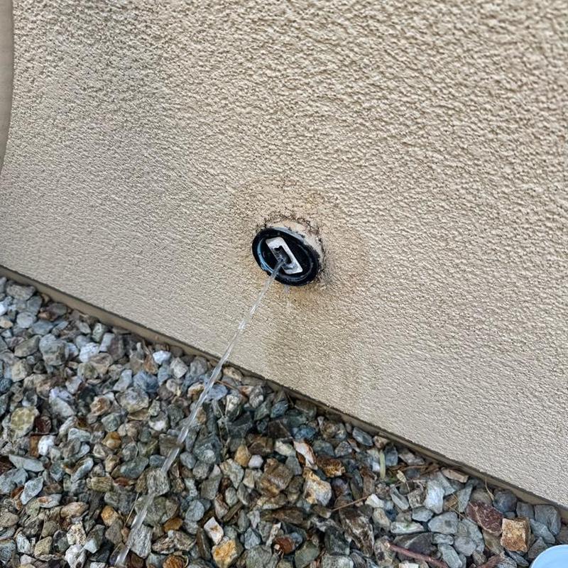 Outdoor plumbing clean-out with flowing water Outdoor plumbing clean-out with flowing water