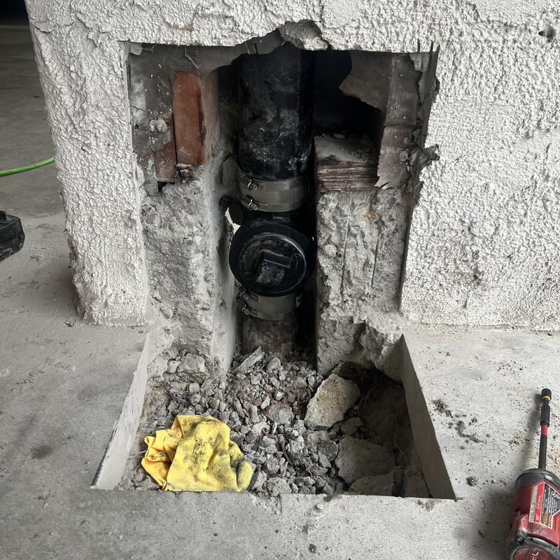 Cast iron sewer clean out tee in concrete wall