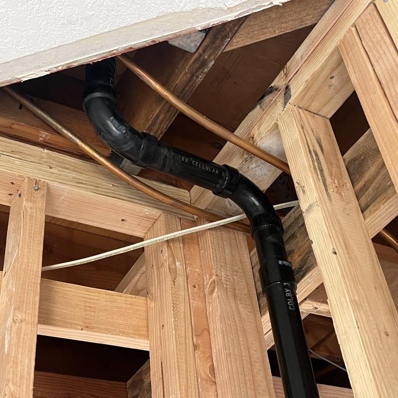 Kitchen rough-in plumbing with black PVC pipes