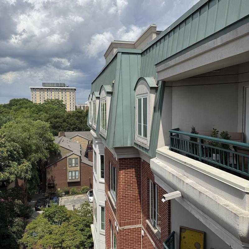 Roof moisture assessment using Tramex meter on building exterior