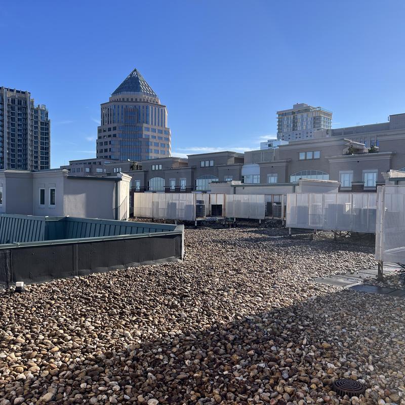Gravel-covered flat roof with downtown buildings in background