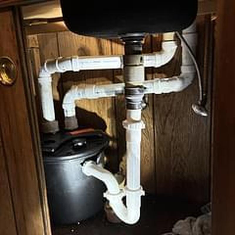Laundry pump and kitchen drain pipe reroute under sink