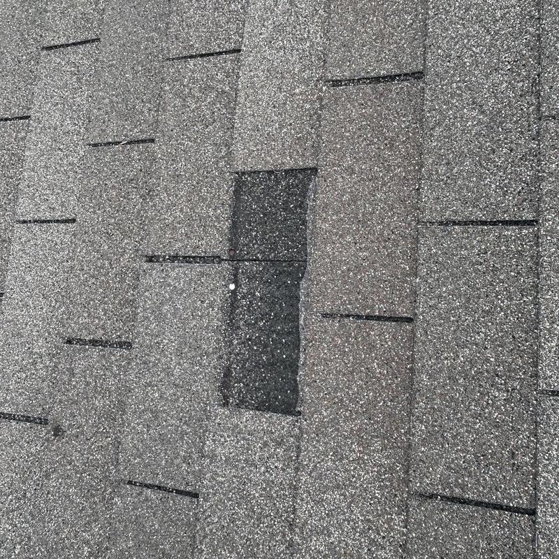 Asphalt shingles with missing granules on roof