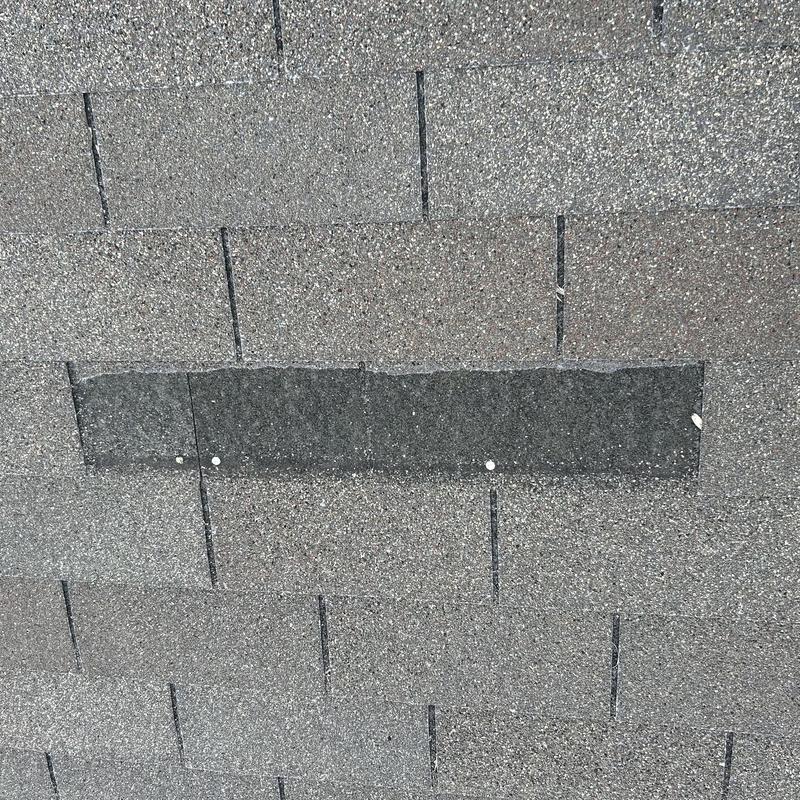 Asphalt roof shingles with patch repair section