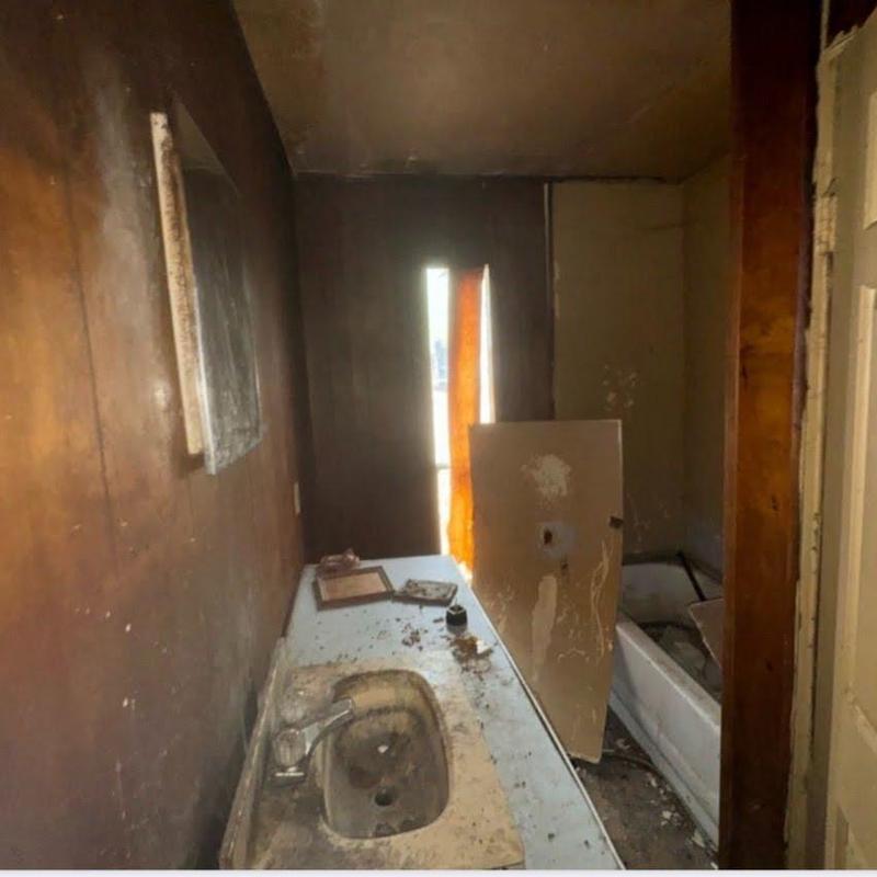 Bathroom sink and tub with heavy dirt and damage