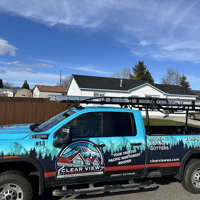 Roofing and gutter service truck with ladder rack