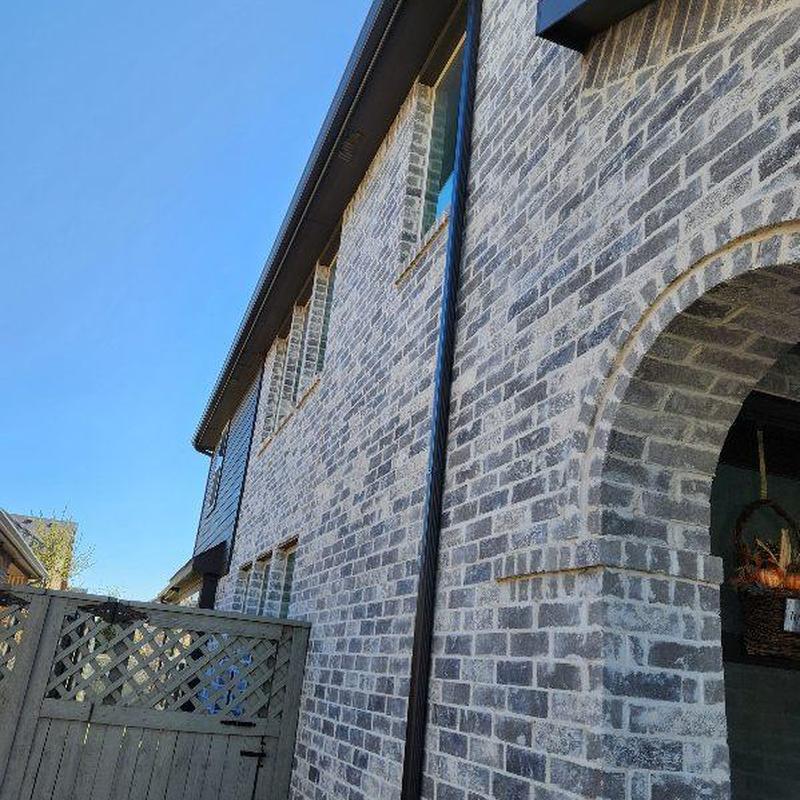 Gutter and downspout on brick house exterior