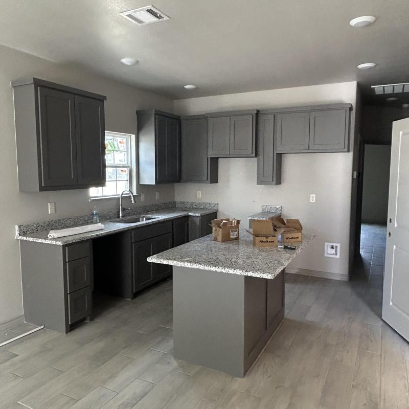 Kitchen granite countertops and gray cabinets installation