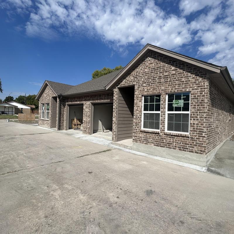 Brick exterior duplex with new roofing and windows