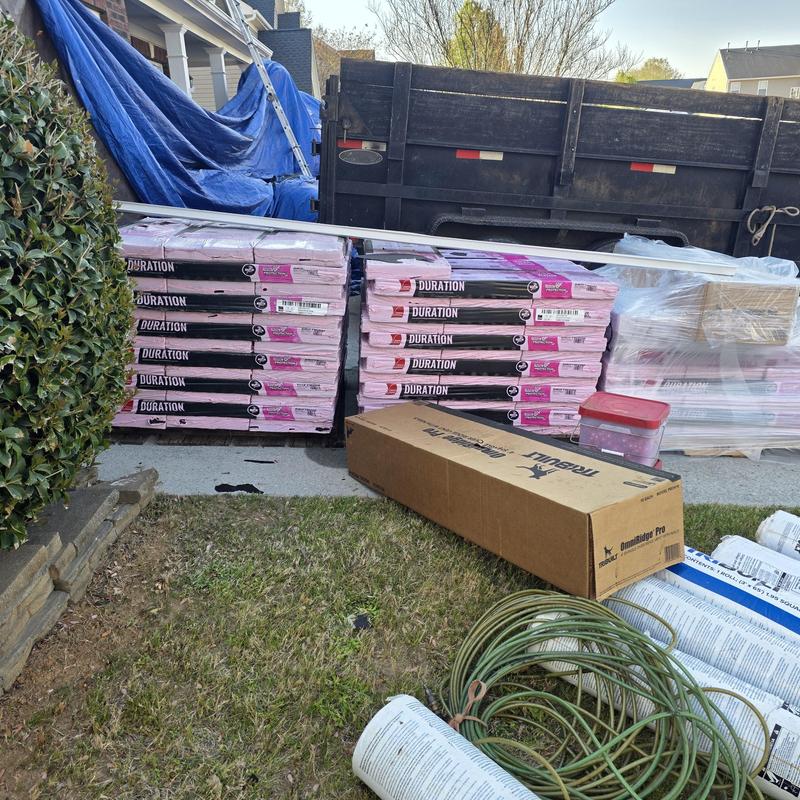 Architectural Duration Sure Nail shingles stacked outdoors Architectural Duration Sure Nail shingles stacked outdoors
