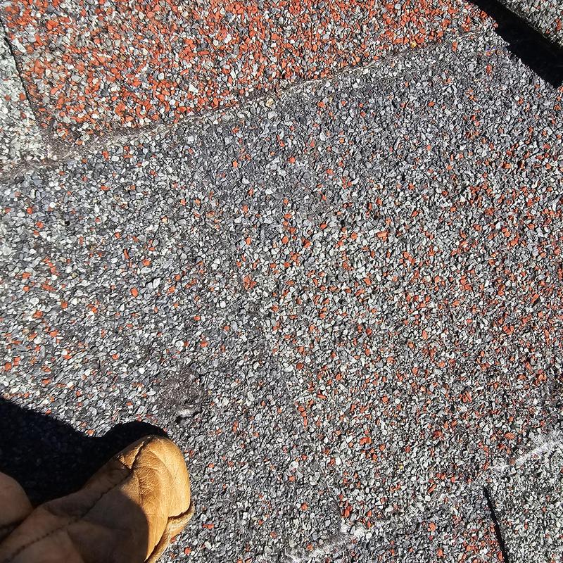 Asphalt shingle roof hail damage close-up in Terrell TX