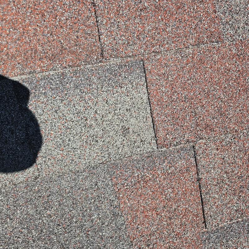 Asphalt shingle roof with hail damage close-up