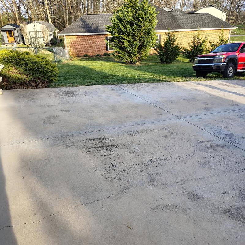 Concrete driveway with cracks and surface stains