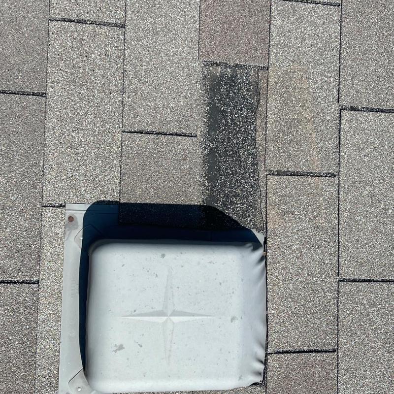 Roof shingles with hail damage around vent flashing