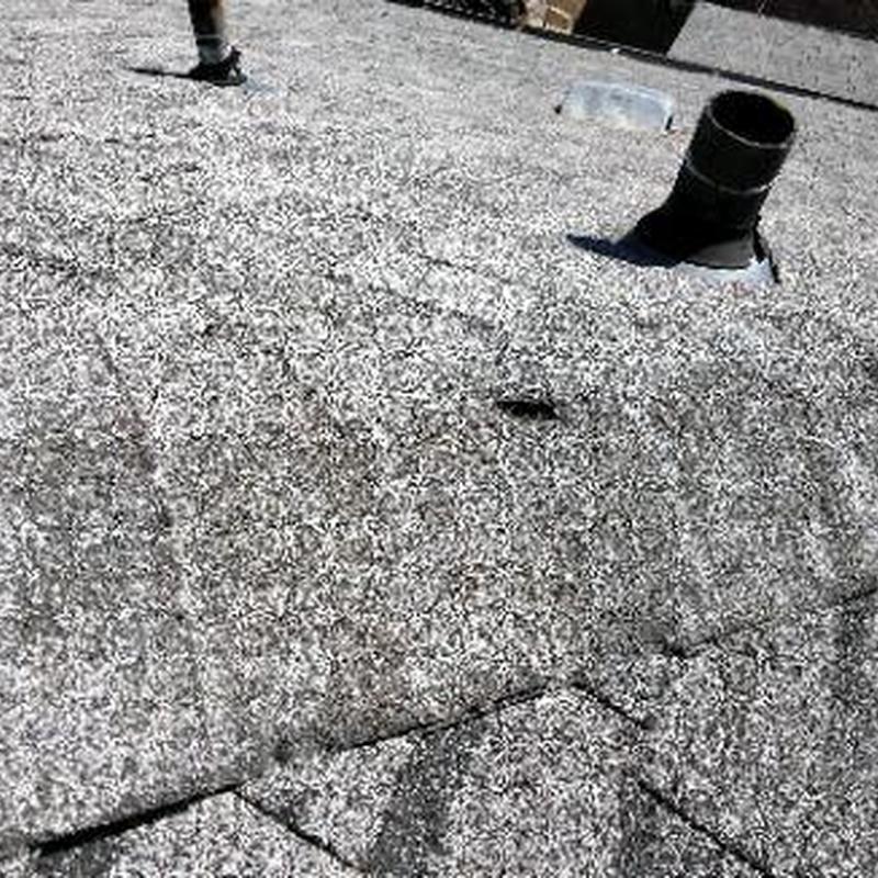 Shingle roof with cracked ridge cap and flashing issues