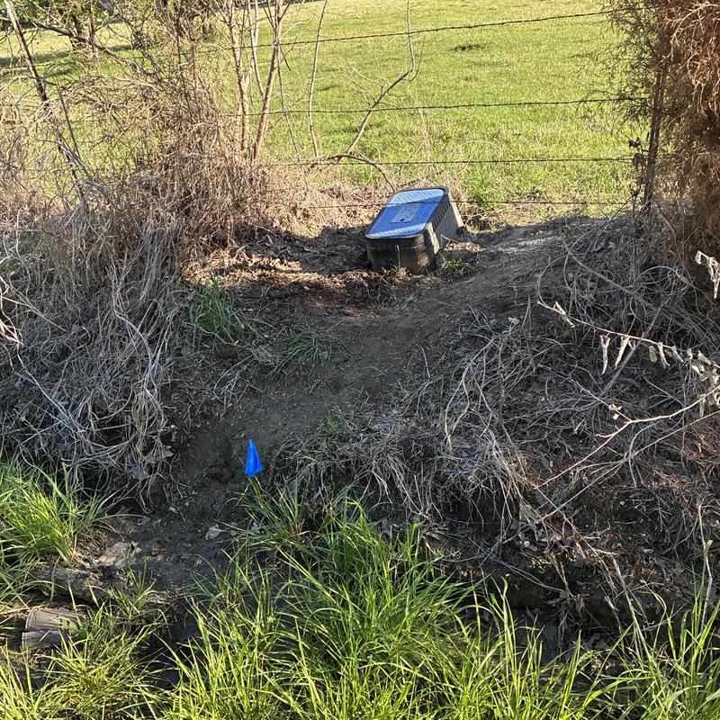 Ditch water line and meter box in grassy area