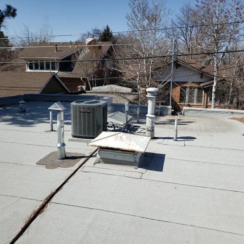 Flat roof with pipe jacks and HVAC unit inspection